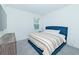 Inviting bedroom with a plush blue bed, soft carpet, and ample natural light from a window at 1433 Halpern Ln, Kennesaw, GA 30144