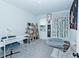 Cozy bedroom offers a comfy chair, desk, shelves, and stylish decor at 1433 Halpern Ln, Kennesaw, GA 30144