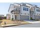 Charming two-story townhome with a gray garage door, balcony, and manicured lawn at 1433 Halpern Ln, Kennesaw, GA 30144
