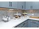 Modern kitchen counter with gray cabinetry, quartz countertops, and herringbone backsplash at 1433 Halpern Ln, Kennesaw, GA 30144