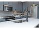 The modern kitchen boasts stainless steel appliances and stylish gray cabinetry at 1433 Halpern Ln, Kennesaw, GA 30144