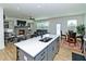 Bright open floor plan with modern kitchen island, hardwood floors, and a cozy living area at 1433 Halpern Ln, Kennesaw, GA 30144