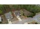 Overhead shot showcases the home, driveway, nearby residence, and adjacent undeveloped green space at 164 Madison Grace Ave, Mcdonough, GA 30252