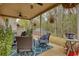Inviting covered back porch with comfortable seating, outdoor grill, and backyard views at 164 Madison Grace Ave, Mcdonough, GA 30252