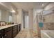 Well-appointed bathroom featuring double vanity sinks, tile flooring, and separate shower and tub at 164 Madison Grace Ave, Mcdonough, GA 30252