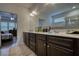 A view into the bright main bathroom from the bedroom featuring double vanities, shower and tub at 164 Madison Grace Ave, Mcdonough, GA 30252