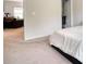 Bright bedroom transitions to living area with plush carpet and white walls at 164 Madison Grace Ave, Mcdonough, GA 30252