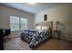 Bright bedroom features neutral walls, carpeted floor, and comfortable bed with blue and white floral bedding at 164 Madison Grace Ave, Mcdonough, GA 30252