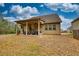 Exterior view of home featuring covered back porch, green yard, and charming neighborhood setting at 164 Madison Grace Ave, Mcdonough, GA 30252