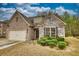 Charming single-Gathering home with a combination of brick and stone facade, and manicured front yard landscaping at 164 Madison Grace Ave, Mcdonough, GA 30252