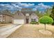 Charming single-Gathering home featuring a brick and stone facade, landscaped yard, and a two-car garage at 164 Madison Grace Ave, Mcdonough, GA 30252