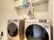 Laundry room featuring side-by-side washer and dryer, and overhead wire shelving at 164 Madison Grace Ave, Mcdonough, GA 30252