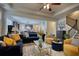 Open-concept living room with hardwood floors, modern furniture, and a view of the kitchen and staircase at 164 Madison Grace Ave, Mcdonough, GA 30252