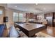 Entertainment area showing a pool table and kitchen area with stainless steel appliances at 164 Madison Grace Ave, Mcdonough, GA 30252