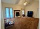 Spacious living room with fireplace, ceiling fan and natural light at 204 Appalachee Church Rd, Auburn, GA 30011