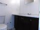 Standard bathroom features a toilet, vanity with marble countertop, and dark cabinetry at 3695 Church St, Clarkston, GA 30021