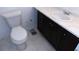 Standard bathroom features a toilet, vanity with marble countertop, and dark cabinetry at 3695 Church St, Clarkston, GA 30021