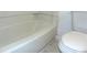 Standard bathroom features a toilet and a tub with a standard shower at 3695 Church St, Clarkston, GA 30021