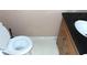 Cozy bathroom with a stylish black countertop and wooden vanity at 3695 Church St, Clarkston, GA 30021