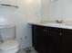 Standard bathroom features a toilet, vanity with marble countertop, and dark cabinetry at 3695 Church St, Clarkston, GA 30021