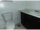 Bathroom featuring a toilet and a vanity with marble countertop at 3695 Church St, Clarkston, GA 30021