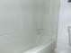 Bathroom with a clean white tub and shower combo with built in shelving at 3695 Church St, Clarkston, GA 30021