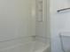 Bathroom with a clean white tub and shower combo with built in shelving at 3695 Church St, Clarkston, GA 30021
