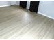 Bedroom showcasing newly installed, light-colored, wood-look plank flooring at 3695 Church St, Clarkston, GA 30021