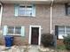 Brick townhouse with colorful shutters and well-maintained landscaping at 3695 Church St, Clarkston, GA 30021
