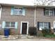 Brick townhouse with colorful shutters and well-maintained landscaping at 3695 Church St, Clarkston, GA 30021