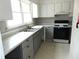 Functional kitchen featuring white cabinets and modern appliances at 3695 Church St, Clarkston, GA 30021