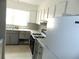 Kitchen with white cabinets, appliances and counter space near a bright window at 3695 Church St, Clarkston, GA 30021