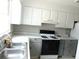 Functional kitchen featuring white cabinets and modern appliances at 3695 Church St, Clarkston, GA 30021