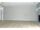Bright living room featuring light walls and wood-look floors leading to the kitchen at 3695 Church St, Clarkston, GA 30021