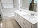 Bathroom featuring double sink vanity, garden tub, and glass enclosed shower at 4093 Chapel Mill Bnd, Decatur, GA 30034