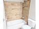 Clean bathroom featuring a shower and tub with light brown tiling and a white toilet at 4093 Chapel Mill Bnd, Decatur, GA 30034