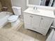 Bathroom featuring sink vanity and toilet with tiled floors and walls at 4093 Chapel Mill Bnd, Decatur, GA 30034