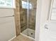 Bathroom featuring glass enclosed tiled shower with tiled accents and a small window at 4093 Chapel Mill Bnd, Decatur, GA 30034
