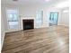 Bright living room featuring a fireplace, modern floors, and open layout at 4093 Chapel Mill Bnd, Decatur, GA 30034