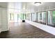 Bright sunroom featuring wood flooring, large windows, and sliding doors for indoor/outdoor living at 4093 Chapel Mill Bnd, Decatur, GA 30034