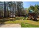 Spacious backyard featuring a playset, trampoline, and storage shed at 5960 Sarah Orr Ln, Cumming, GA 30040