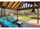 Relaxing covered patio with plush seating, TV, and a view of the spacious backyard with play set at 5960 Sarah Orr Ln, Cumming, GA 30040