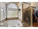 Bright bathroom features a soaking tub, walk-in shower, and a large window at 5960 Sarah Orr Ln, Cumming, GA 30040