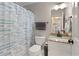 Small bathroom features a granite sink, tiled floors, and a shower/tub combo at 5960 Sarah Orr Ln, Cumming, GA 30040