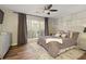 Bright bedroom features a large window, built-in shelves and hardwood floors at 5960 Sarah Orr Ln, Cumming, GA 30040