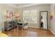 Cozy bedroom has hardwood floors, a mirror, and a large window at 5960 Sarah Orr Ln, Cumming, GA 30040