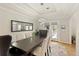 Elegant dining area with modern lighting fixture, large window, and neutral color palette at 5960 Sarah Orr Ln, Cumming, GA 30040