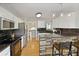 Kitchen with stone island accents, stainless steel appliances, and hardwood floors at 5960 Sarah Orr Ln, Cumming, GA 30040