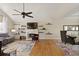 Open concept living area with fireplace, hardwood flooring, vaulted ceiling, and natural light at 5960 Sarah Orr Ln, Cumming, GA 30040