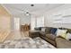 Spacious living room features a sectional couch, wood flooring, and neutral decor at 5960 Sarah Orr Ln, Cumming, GA 30040